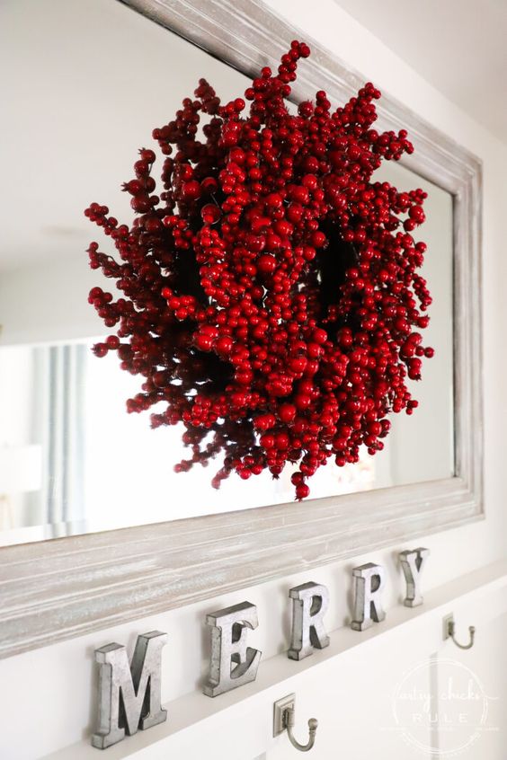 A Christmas wreath composed of red ornaments and faux berries looks very bold, eye catchy and super cool