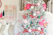 a bright and fun Christmas silver tree with pink, hot pink and green ornaments, beads and striped ornaments and stars