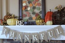 a bright vintage Thanksgiving mantel with bold pumpkins, berries, and string art with colorful paper leaves