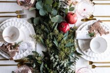 a lush greenery runner and some ripe pomegranates will make your tablescape ultimately fall chic and Thanksgiving-ready