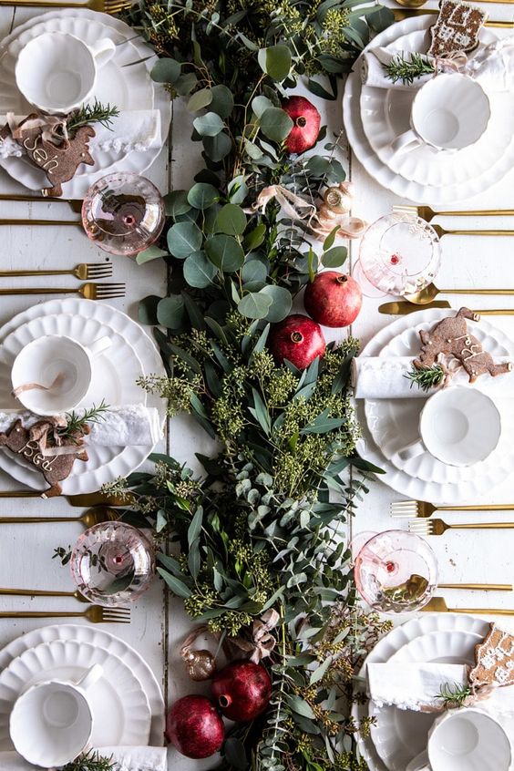 A lush greenery runner and some ripe pomegranates will make your tablescape ultimately fall chic and Thanksgiving ready