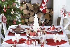 a modern red and white Christmas table setting, red and wwhite ornaments and stockings