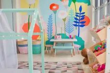 a pastel kid’s room with a bright floral wall, a mint house-shaped bed, colorful toys and a bold rug and baskets