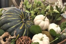 a pretty Thanksgiving centerpiece of a wooden box, pumpkins, moss, a vine ball and greenery is a rustic or a woodland solution