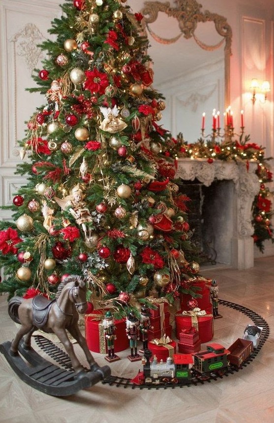 a sophisticated Christmas tree with gold and red ornaments, leaves, branches, ribbons and flowers is wow