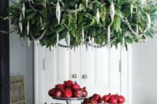 an oversized green chandelier and silver ornaments will make a statement in your kitchen or any other holiday space
