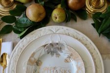 vintage patterned white plates and a copper and silver printed one on top are perfect for creating an elegant and slightly vintage Thanksigiving tablescape