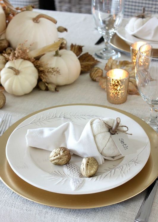 white pumpkins, dried leaves, gilded nuts and candles in mercury glass candleholders for a chic and refined Thanksgiving tablescape