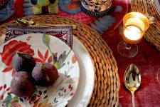 woven placemats, a silver polka dot plate, a bright floral print one and a purple patterned napkin for a bright Thanksgiving table