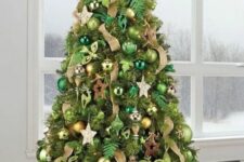a Christmas tree with bold green and emerald ornaments, gold and copper ones, ribbons and wooden stars