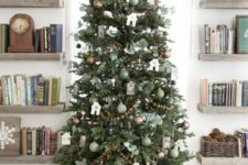 a beautiful cottage Christmas tree with brown and green ornaments, wooden bead garlands, leaves and a vine star on top