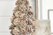 a bleached pinecone Christmas tree on a stand is a very cool and cozy farmhouse or woodland decor idea for winter