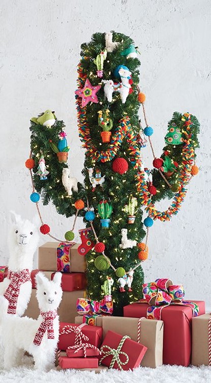 a cactus Christmas tree with colorful ornaments, garlands and lights and little alpaca figurines