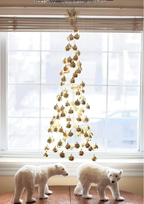 a floating Christmas tree made of gold ornaments is a stylish and super glam decor idea for holidays