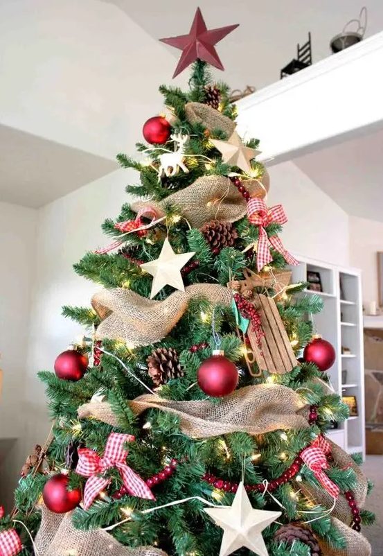 a gorgeous rustic Christmas tree with pinecones, wooden stars and sledges, red balls and plaid bows, a star on top
