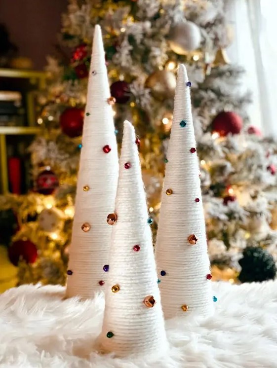 Very easy Christmas decor   white yarn wrapped cones decorated with bold bells and beads that are super cool