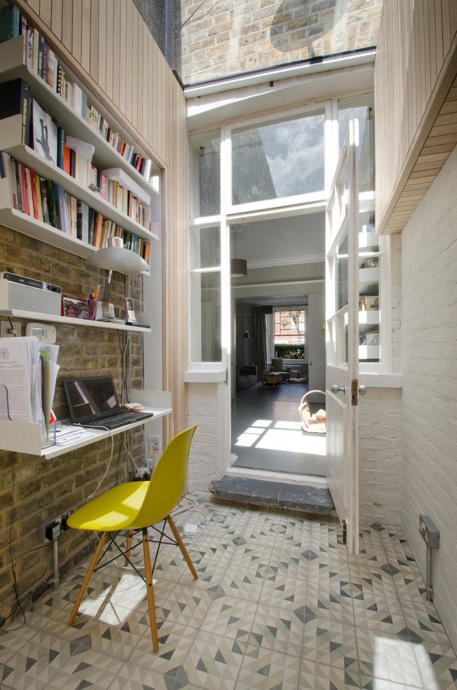 Patterned tiles and exposed brick walls are perfect decorating solutions you could use for a home office.  (Gort Scott)