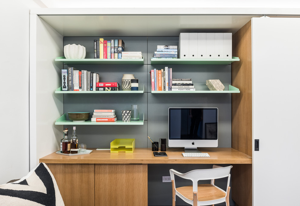 Make your home office a part of a storage wall for a more built-in look.