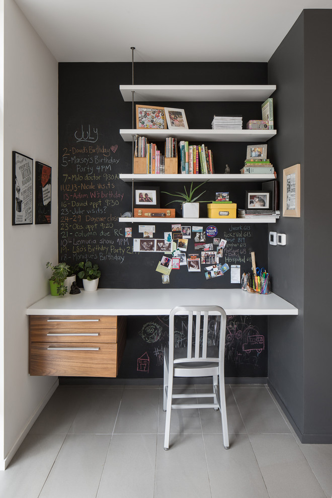 A contemporary black and white home office in a hallway. It features a chalkboard wall that is a perfect addition to any working space. (John Donkin Architect Inc.)