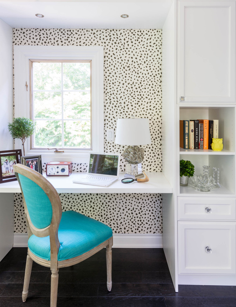 Dark hardwood flooring and a wallpaper with animal pattern is an interesting mix for a compact feminine home office design. (Carriage Lane Design-Build Inc.)