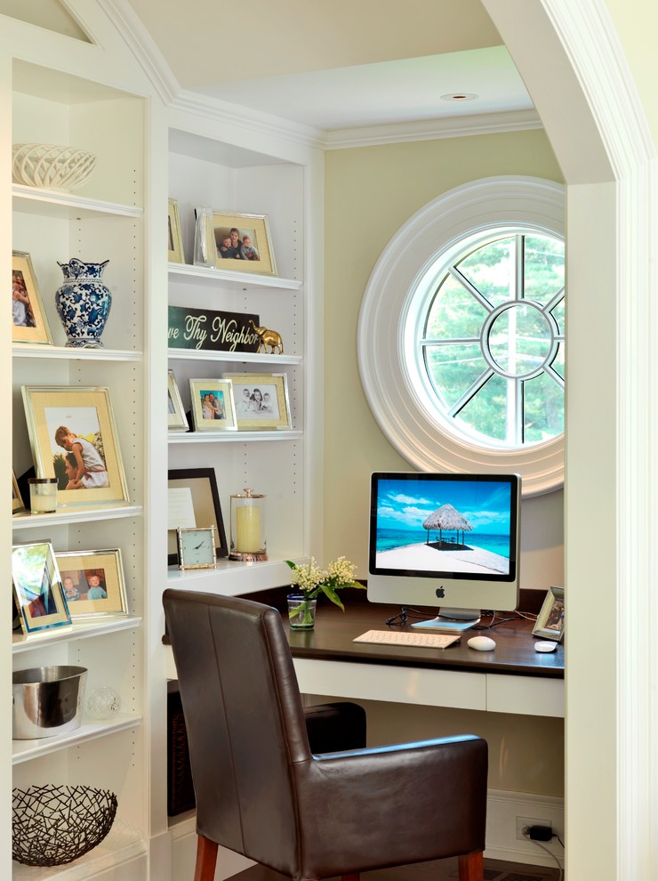 An ox-eye window can become a focal point of a tight alcove home office.