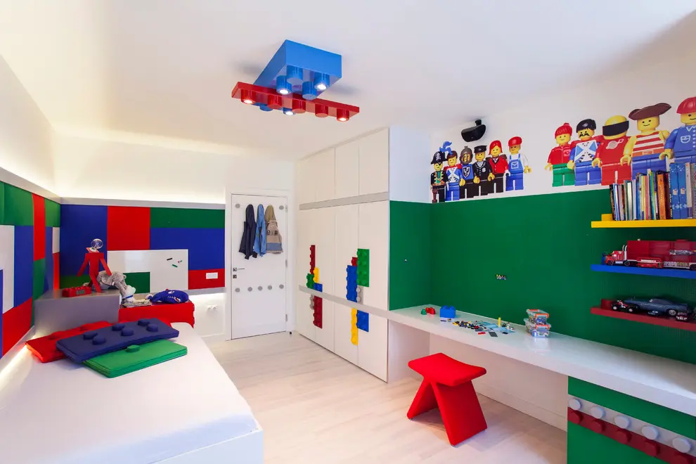 Lego-inspired light fixture, pillows, murals, and cabinets turn this room into a lego's fanboy heaven!