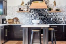 a black kitchen with a beautiful geometric ombre tile backsplash that is a whole masterpiece in here