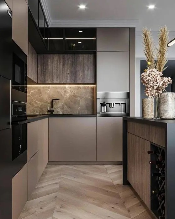 A sophisticated taupe contemporary kitchen with dark stained and taupe cabinets, grey marble and black fixtures plus black built in appliances