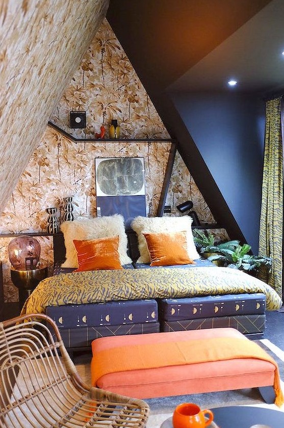 a vivacious attic bedroom with botanical walls and a black one, a navy bed, a coral ottoman, bright bedding and shelves