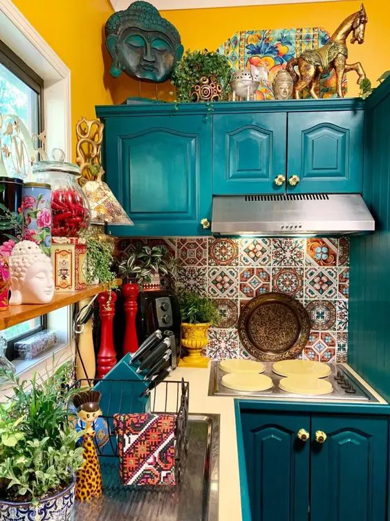 a bright kitchen with teal cabinets, mismatching tile backsplash, colorful accessories and bold accents is fun