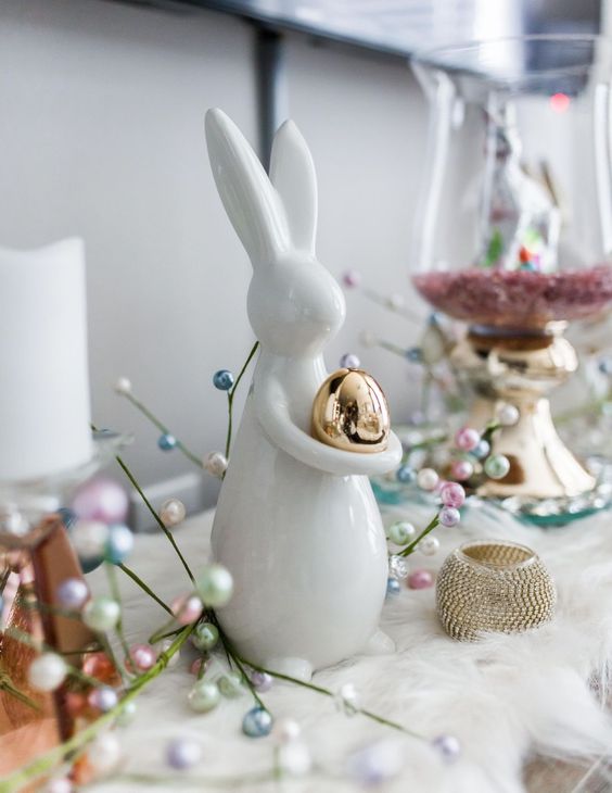 a bunny holding a metallic egg looks super cute and adorable and can decorate your space for spring or Easter