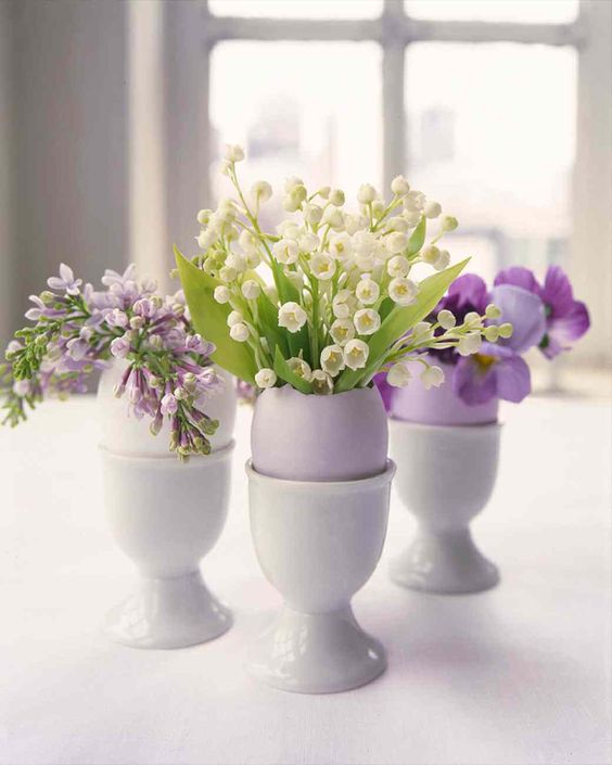 a cluster Easter centerpiece of lilac egg shells with white and purple blooms is a super cool idea
