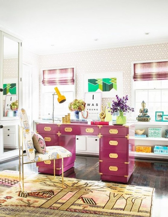 a colorful home office in neutrals, with a hot pink desk, a bold rug, touches of turquoise and striped curtains