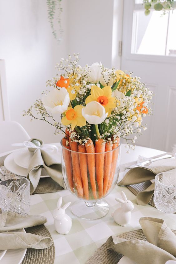 A cool last minute Easter centerpiece of carrots, white tulips, daffodils and baby's breath is a super cool arrangement