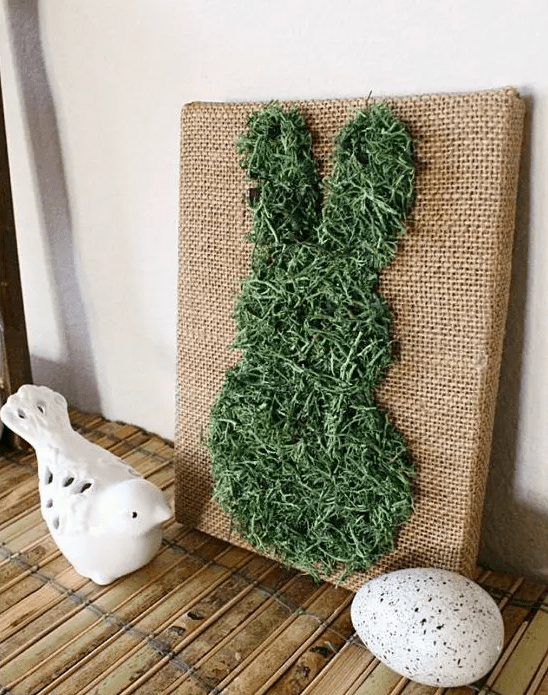 a pretty burlap artwork with a moss bunny is a lovely decoration for a rustic space and it’s not difficult to make
