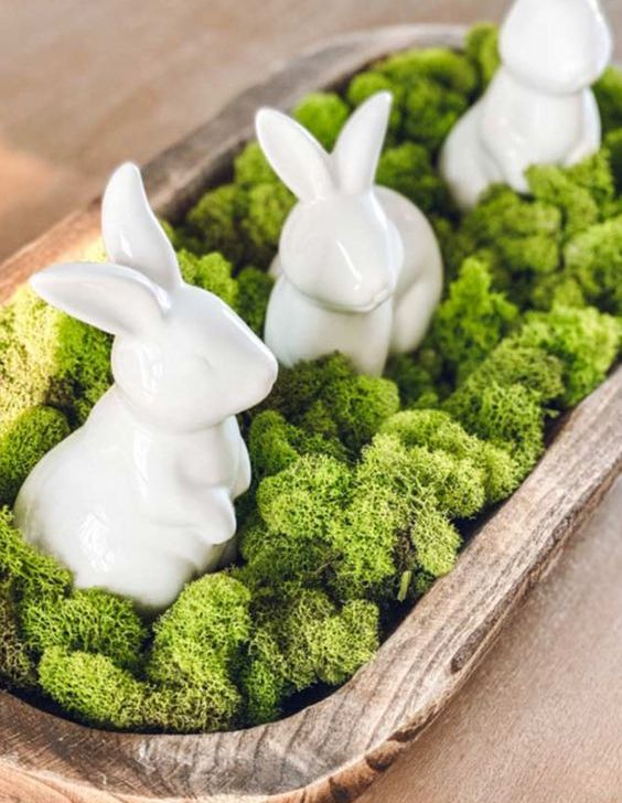 a very simple Easter centerpiece of a tray with moss and bunnies can be a decoration for any mantel or console, too