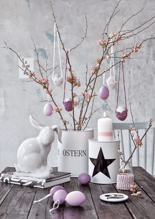 faux blooming branches decorated with lilac and white eggs in egg cozies are a cool Easter tree to rock