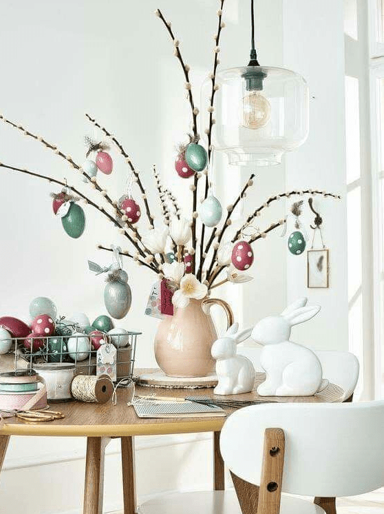 Willow branches with pastel colored fake eggs and some faux blooms are amazing for spring or Easter