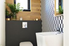 a chic guest toilet with a geometric wall, a plywood one, a blakc accent, a free-standing sink and a fabric basket