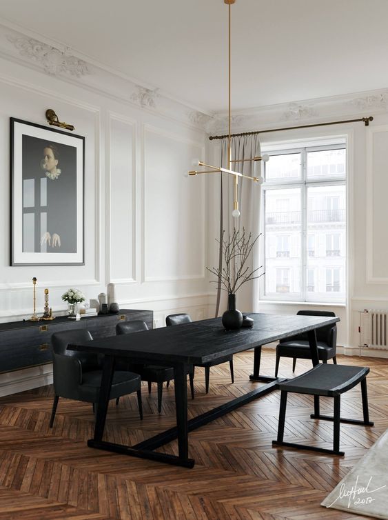 a refined black and white dining room with a black credenza, a black table and chairs, a modern chandelier and a statement artwork