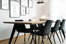 a stylish modern dining space wiht a lightweight dining table, black chairs, a free form gallery wall and pendant lamps
