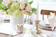 a bright Mother’s Day tablescape with wicker chargers, checked napkins, a pastel floral centerpiece and some mercury glass accessories