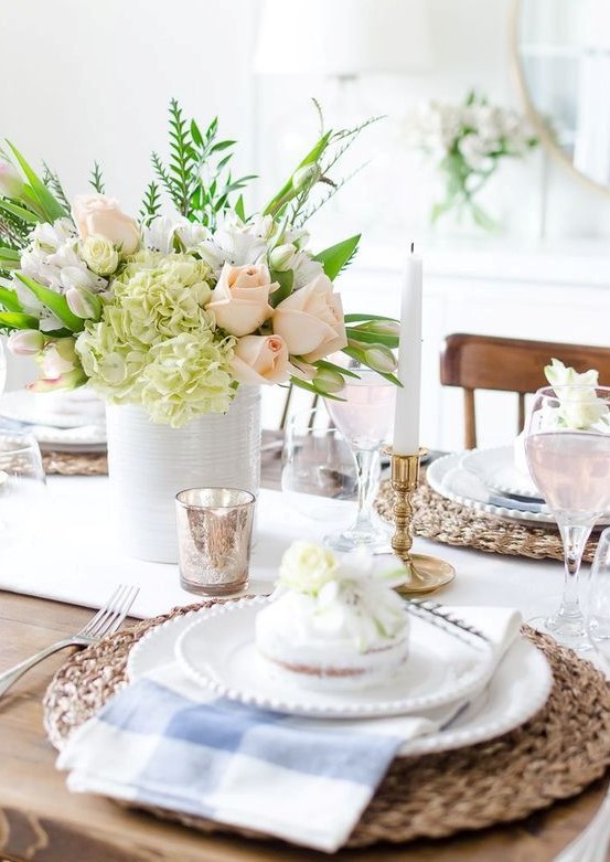 a bright Mother's Day tablescape with wicker chargers, checked napkins, a pastel floral centerpiece and some mercury glass accessories