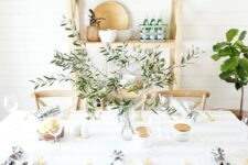 a fresh farmhouse tablescape with striped napkins, an olive branch centerpiece and gold cutlery is cool for Mother’s Day