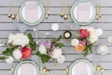 a modern spring tablescape with bright floral centerpieces, blush napkins and geometric touches