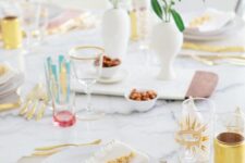 a pretty Mother’s Day table setting with pastel blooms, geode placemats, gold-rimmed plates and colorful touches
