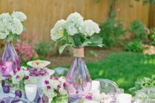 a purple Mother’s Day table setting with white hydrangeas, lilac candleholders and napkins is a catchy one