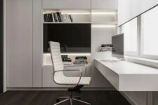 a refined minimalist home office with a large sleek built-in storage unit with built-in lights, a floating desk with storage, a chic white chair