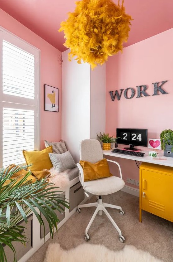 a super bold home office in pink, grey and mustard, with pink walls and a ceiling, with mustard accessories is a unique space