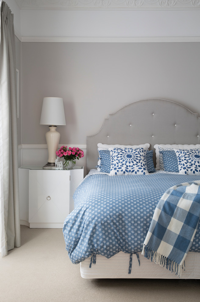 stylish modern classics - dove grey walls, curtains, floor and furniture and blue bedding on the bed